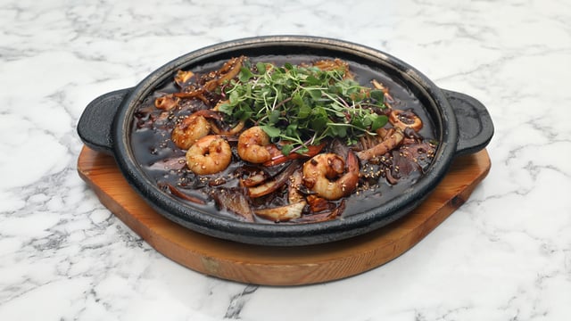 Fideos con salsa de judías negras en plato de piedra 1
