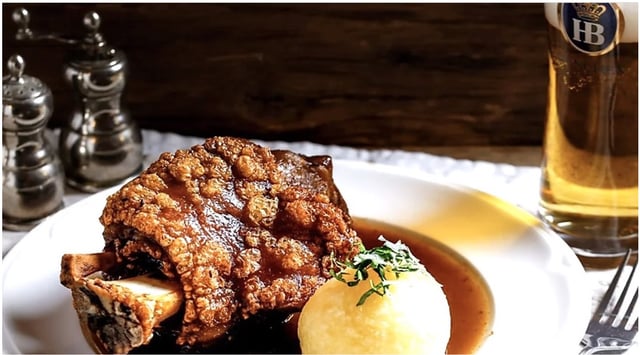 A whole roasted knuckle of pork served with homemade dark beer gravy and a potato dumpling 1
